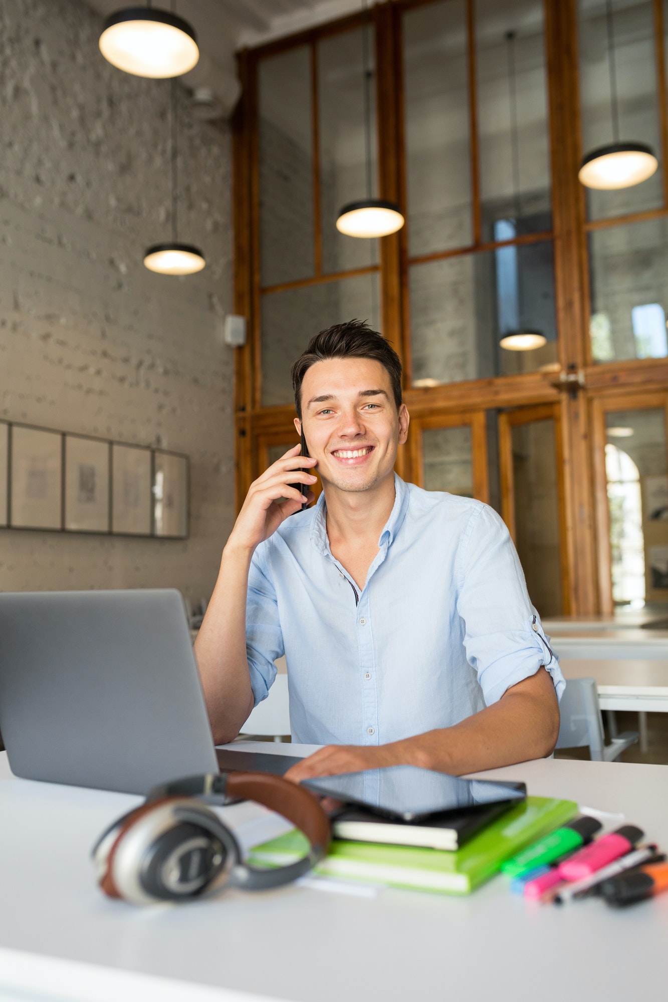 happy young confident man working on laptop